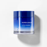 A jar of 'Super Aqua Ultra Hyalron Cream' by Missha, predominantly blue in color with white and grey text, indicating the product is a hydration cream designed to retain moisture in the skin.